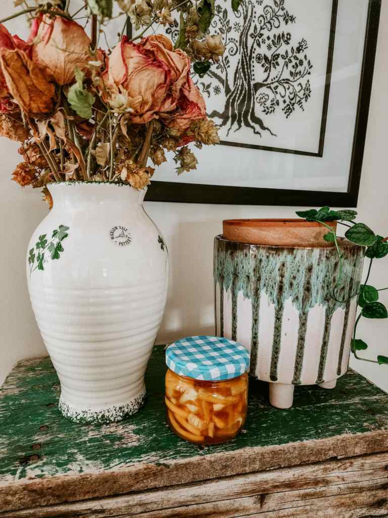 A plaid lid tops a small jar of my homemade could and cold remedy. An anti-flu brew made with lemons, honey and ginger. 