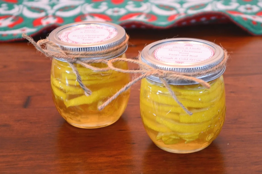 Two small jars of homemade cough and cold remedy. Twine tied around the jars, ready to give as gifts. 