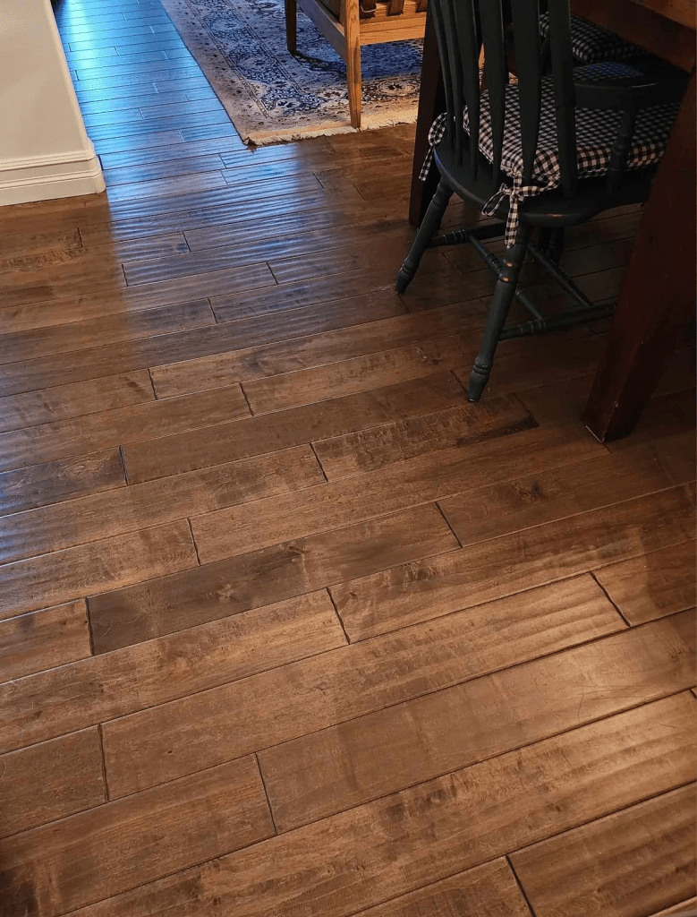 Wavy, etched hardwood floors in a dark mocha colour. 