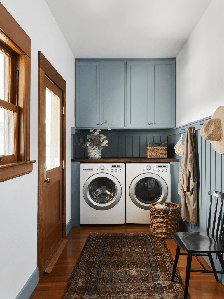 A blue and brown shaker style laundry room.