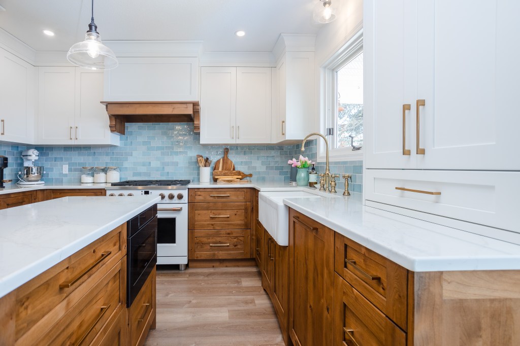 Bright, light kitchen has white upper cabinets and alder wood lowers to add warmth and cosiness. 