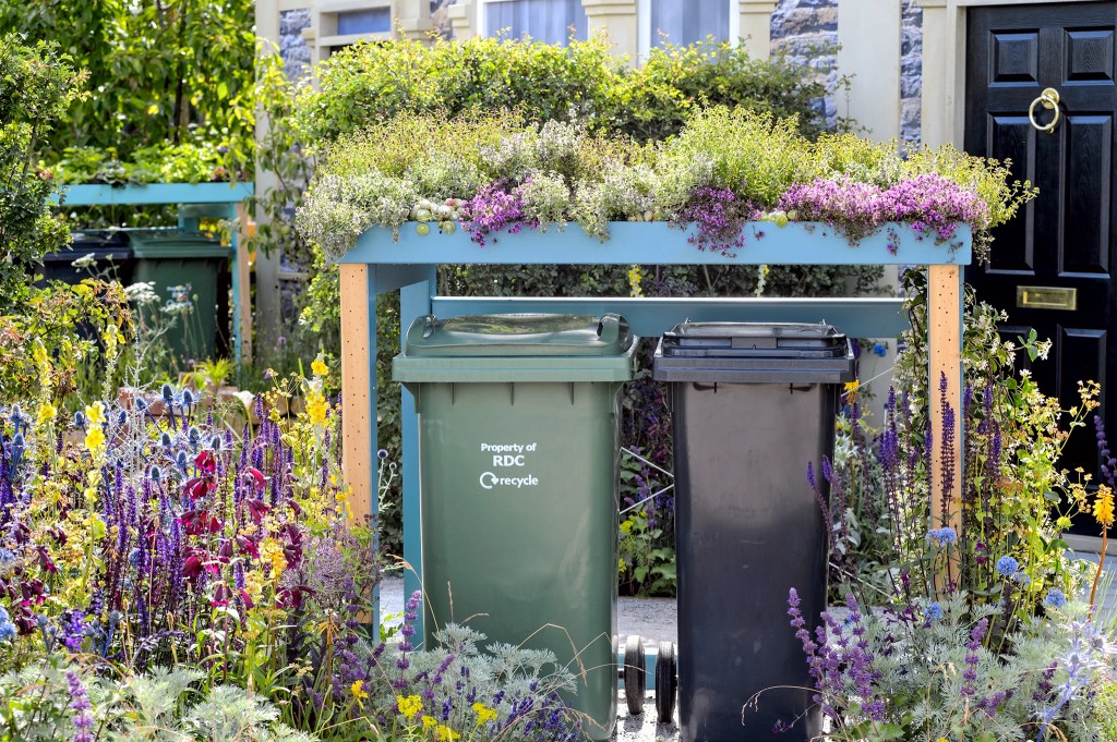 Green roof over garbage bins. 