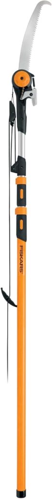 A Fiskars pole pruner with a long adjustable handle and a curved saw blade, designed for reaching and cutting high branches.