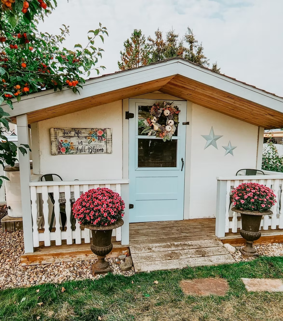 Cute blue and white garden shed with patio. 