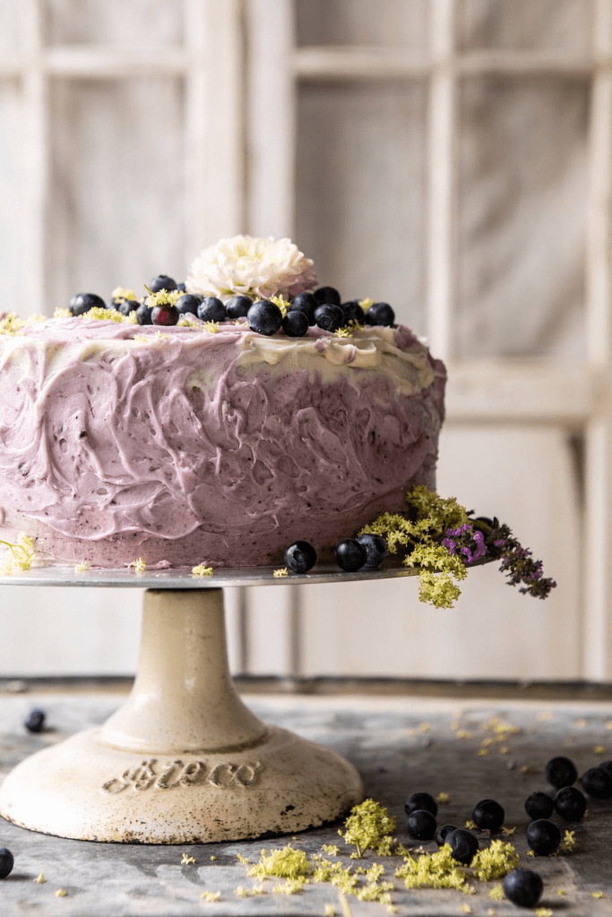 Gorgeous blueberry and lemon cake recipe. Cake is on a vintage raised cake plate, looks so good.  