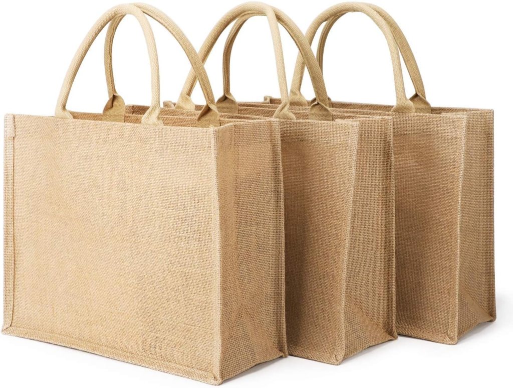 Three jute tote bags with sturdy handles, ideal for shopping or storage.