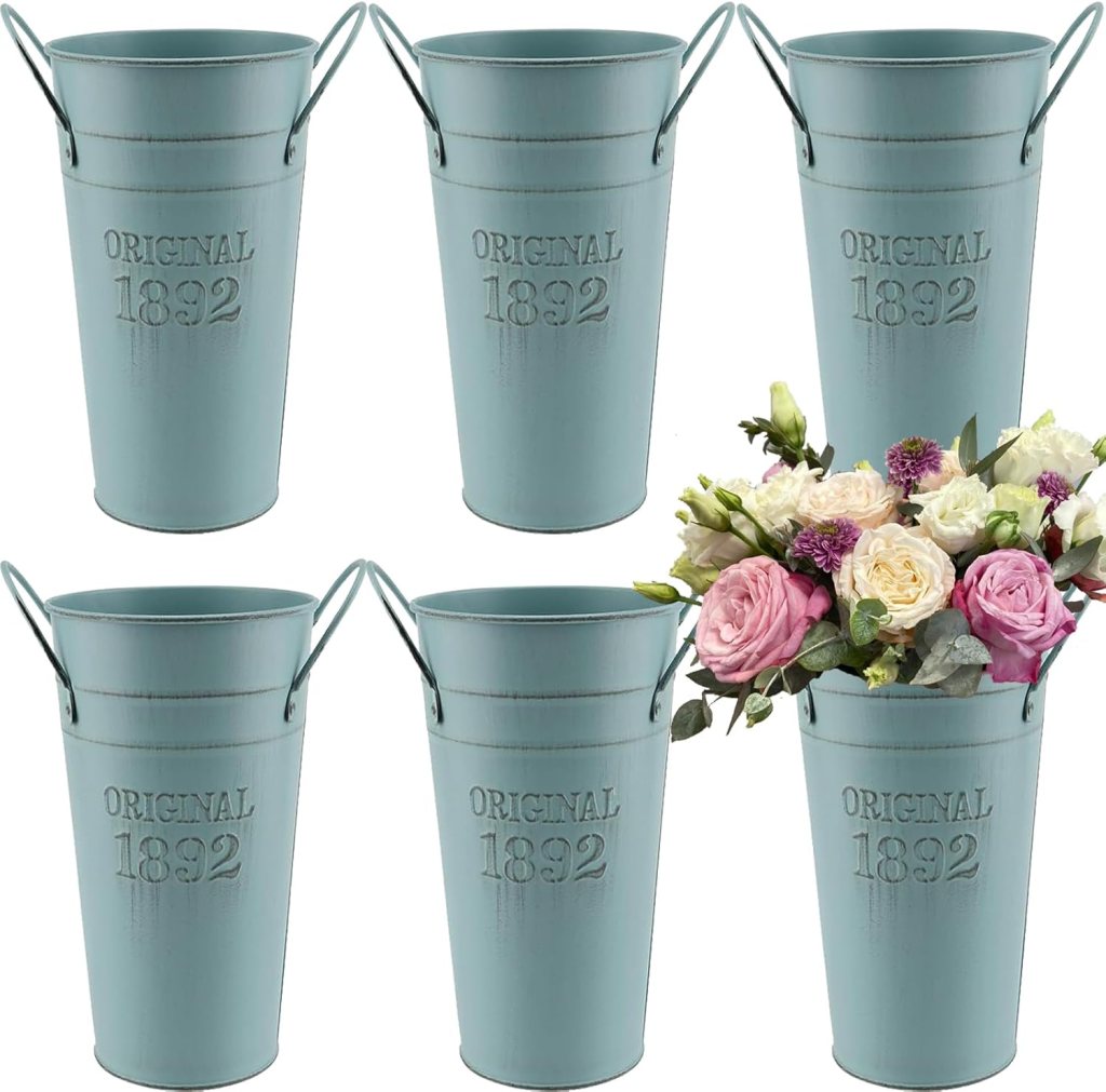 A set of vintage-style metal buckets in a soft blue color, featuring the words 'ORIGINAL 1892' embossed on the front, with one bucket filled with mixed roses and greenery.