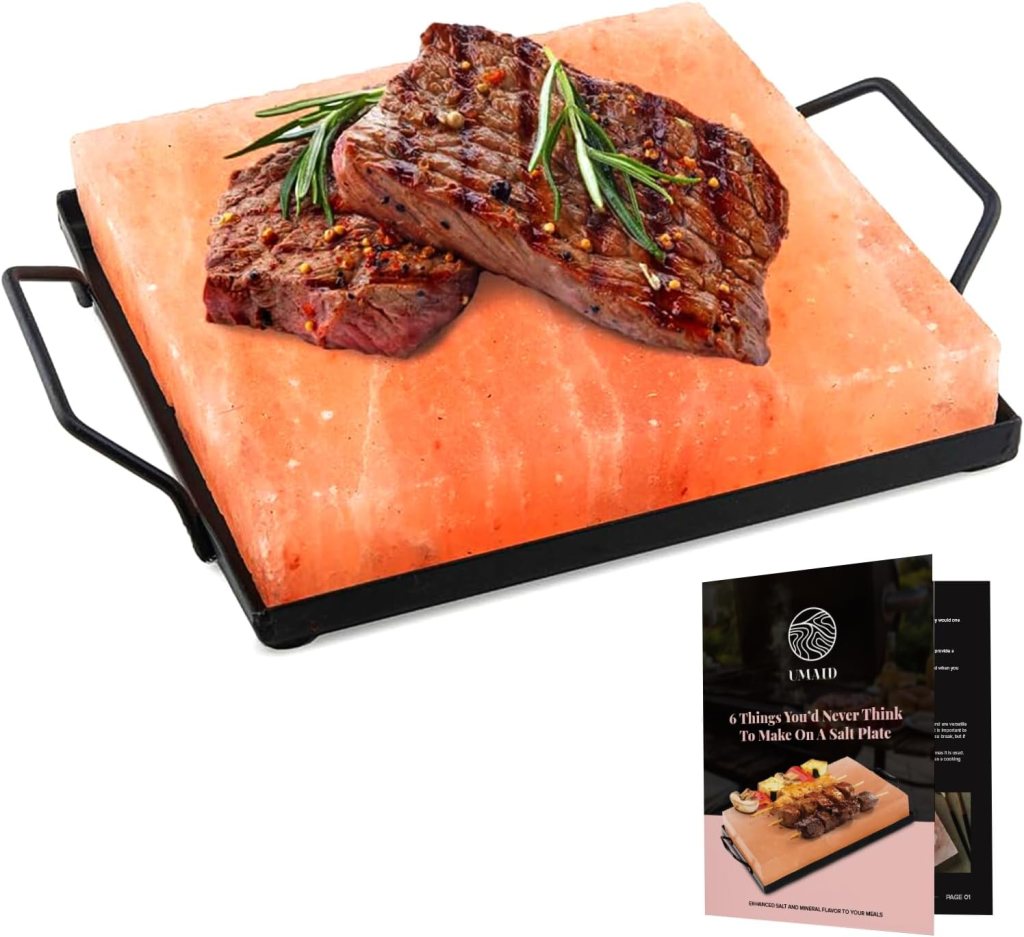 Salt plate with grilled steak topped with herbs and a recipe booklet.