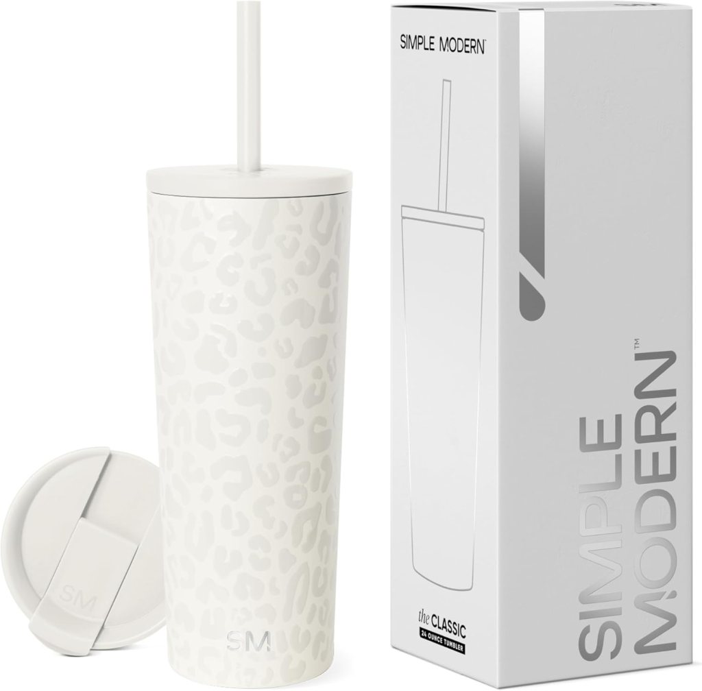 A white insulated tumbler with a leopard print design and a straw, placed next to its packaging box.
