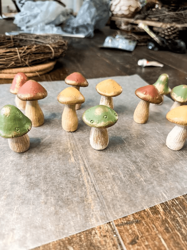 Colorful decorative wooden mushrooms arranged on a table.