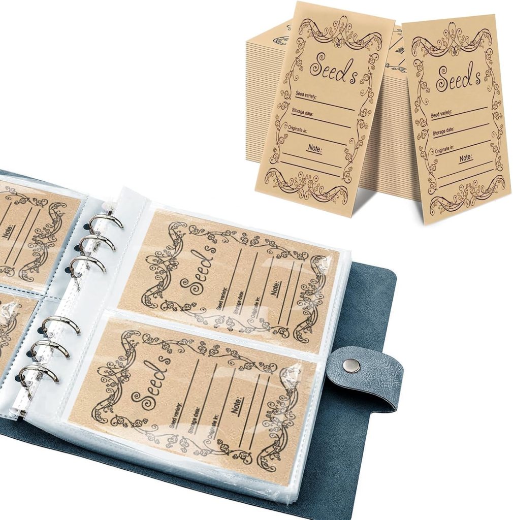 A seed storage binder displaying labeled envelopes for organizing different types of seeds, along with extra seed packets in the background.