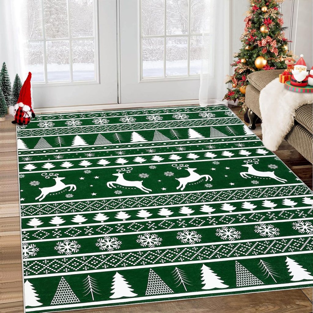 A festive green area rug with white deer, snowflakes, and Christmas tree patterns, placed in front of a large window with snow outside and a decorated Christmas tree nearby.
