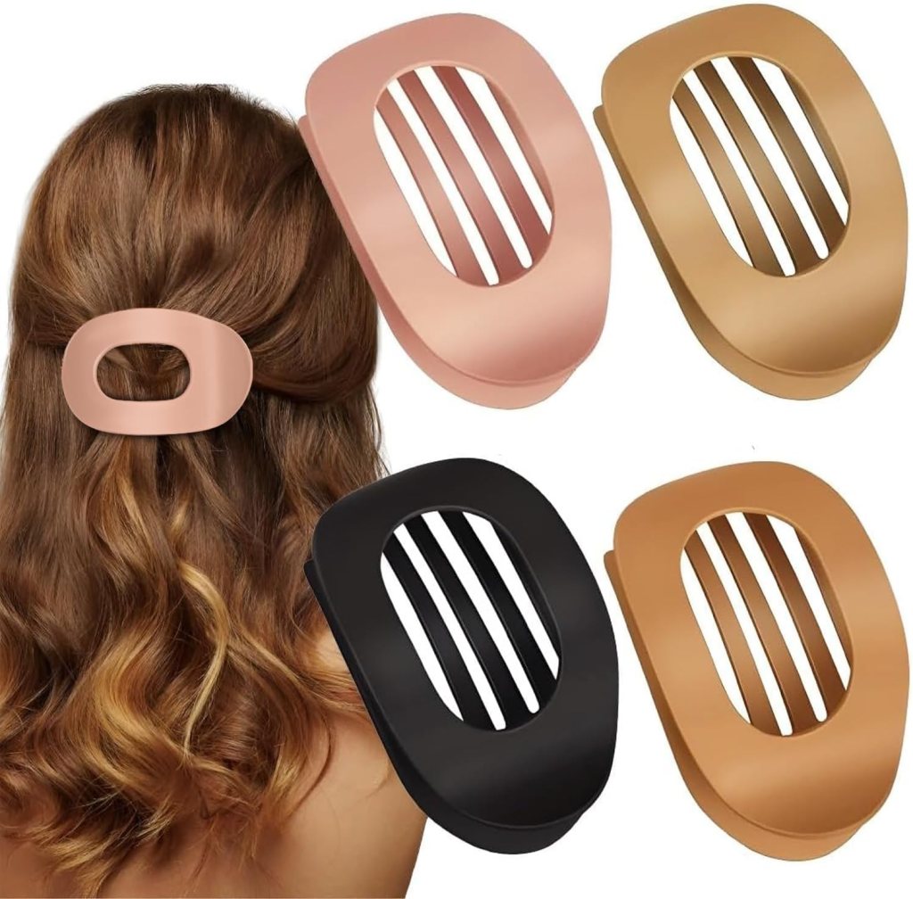 Four stylish hair clips in different colors displayed in a woman's wavy hair.