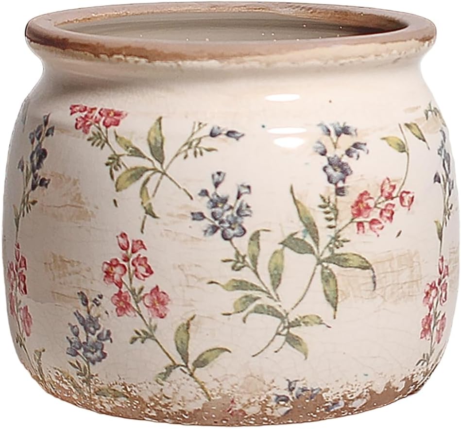 A decorative ceramic pot with a floral pattern featuring red and blue flowers against a cream background.