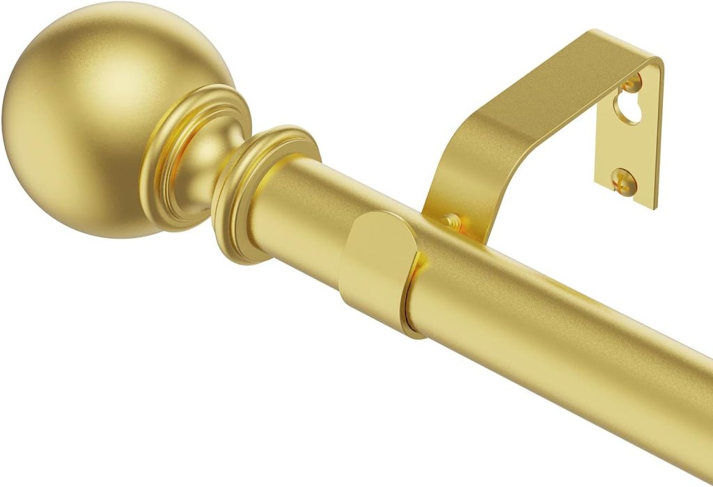 Close-up of a gold curtain rod with a decorative ball end and a bracket for installation.
