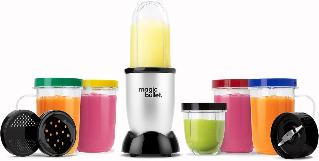 A Magic Bullet blender with a tall blending cup and multiple colorful serving containers, including green, yellow, pink, and orange, arranged around it.