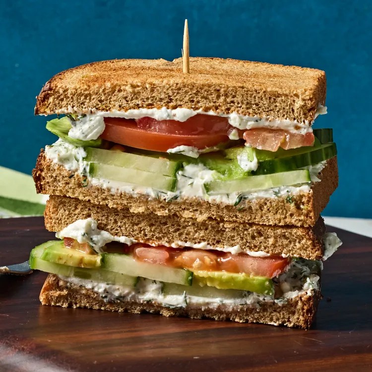 Cucumber, avocado, tomato, and goat cheese sandwich. 